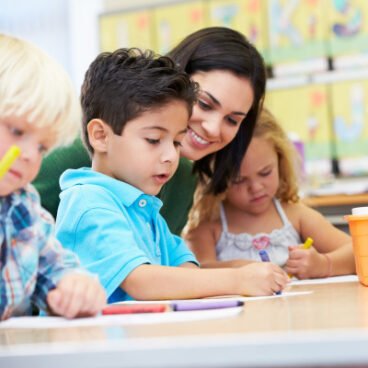 group of elementary age children in art class with teacher
